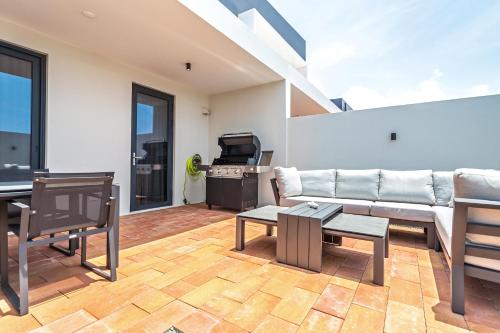 a living room with a couch and a table at Tuscany Residence Aruba in Palm-Eagle Beach