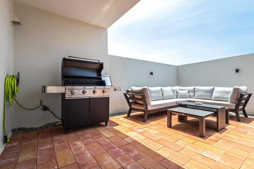 a living room with a stove and a couch at Tuscany Residence Aruba in Palm-Eagle Beach