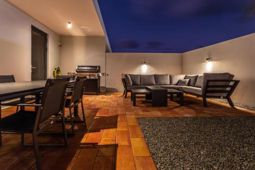 a living room with a couch and a table and chairs at Tuscany Residence Aruba in Palm-Eagle Beach
