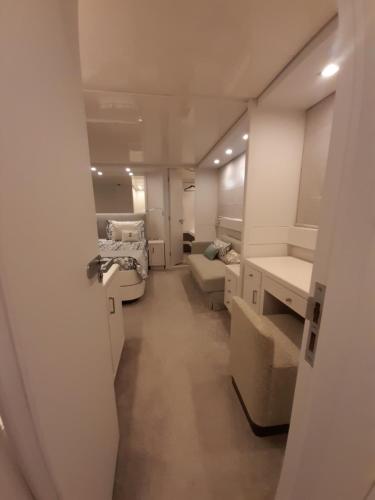 a hallway of a room with two beds and a sink at Luxury Yacht Portosole in Sanremo