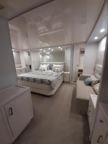 a large white room with a bed and a couch at Luxury Yacht Portosole in Sanremo