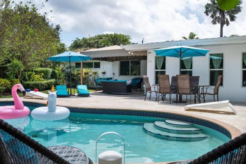 a swimming pool with a pink flamingo in the water at Exclusive Miami House: Your Private Pool Paradise in Biscayne Park