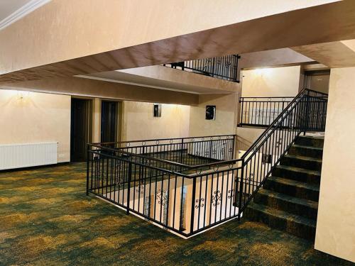 an empty room with stairs in a building at Hotel La Ane in Babadau