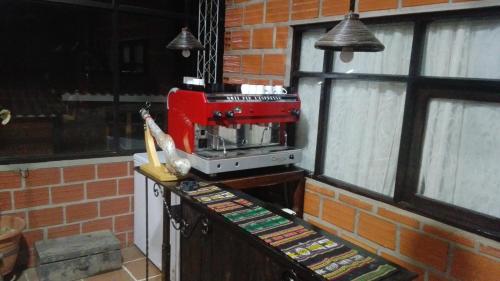 a red sewing machine sitting on top of a counter at Posada del Abuelo in Torotoro