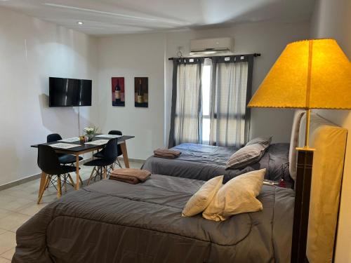 a bedroom with a bed and a table with a desk at Luminoso departamento céntrico in Corrientes