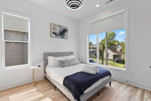 a bedroom with a bed and a large window at Luxurious 4bd home sleeps 12 minutes to downtown with parking in Nashville