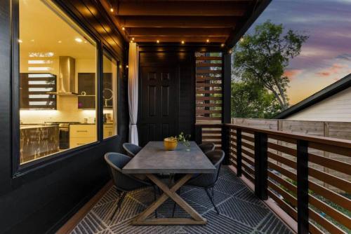 a table on the balcony of a house at Luxurious 4bd home sleeps 12 minutes to downtown with parking in Nashville