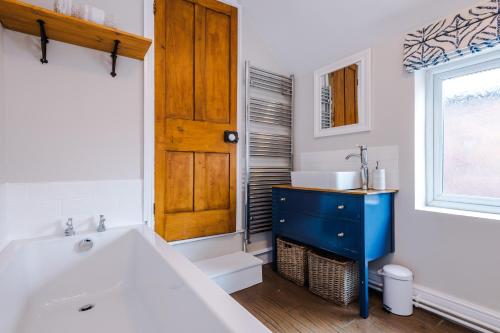 a bathroom with a tub and a sink and a window at Central 2-bed home in Chester by 53 Degrees Property - Amazing location, Ideal for Couples - Sleeps 4! in Chester