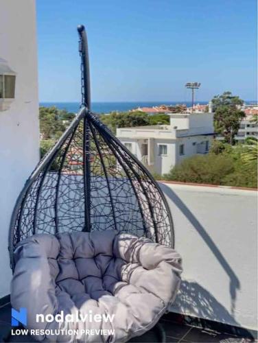 a pillow in a basket on top of a balcony at HIMALAYA ROOFTOP Sea VIEW in Albufeira