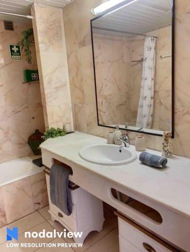 a bathroom with a sink and a mirror at HIMALAYA ROOFTOP Sea VIEW in Albufeira