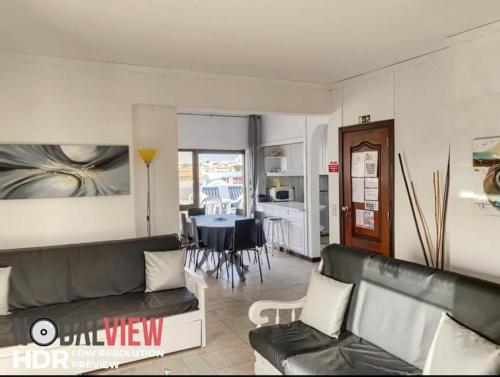 a living room with a couch and a dining room at HIMALAYA ROOFTOP Sea VIEW in Albufeira