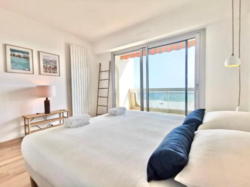 a bedroom with a large bed with a view of the ocean at Vue sur mer La Baule Clara in La Baule