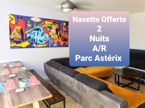 a living room with a couch and a table at La Casa Picasso in Villepinte
