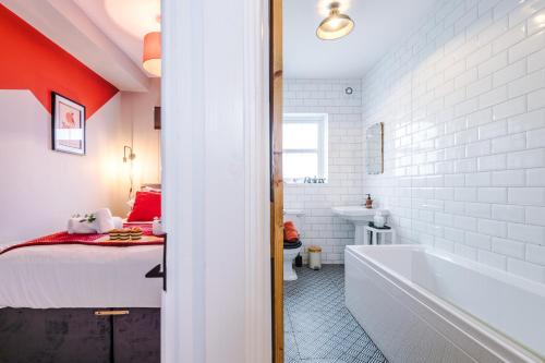 a bathroom with a tub and a bed and a sink at NEW! Gorgeous 2-bed home in Chester City Centre by 53 Degrees Property - Incredible location, Ideal for Small Groups - Sleeps 6! in Chester