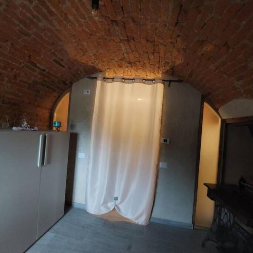 a room with a white curtain on the wall at Istanti - Rosmarino in Costigliole Saluzzo
