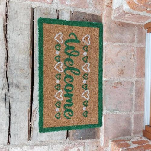 a sign on a brick wall with green writing on it at Istanti - Rosmarino in Costigliole Saluzzo