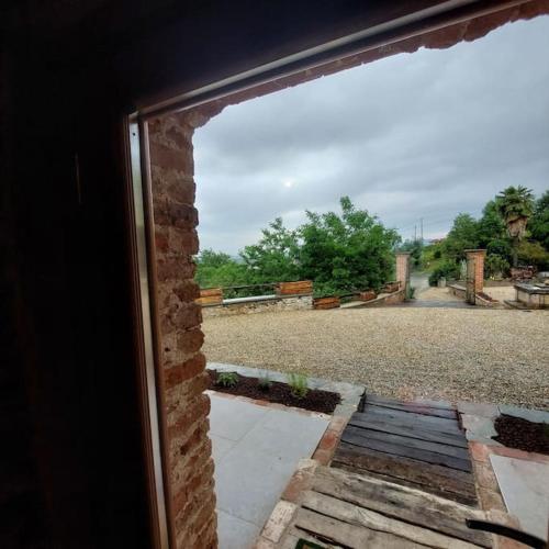 a window view of a driveway from a house at Istanti - Rosmarino in Costigliole Saluzzo