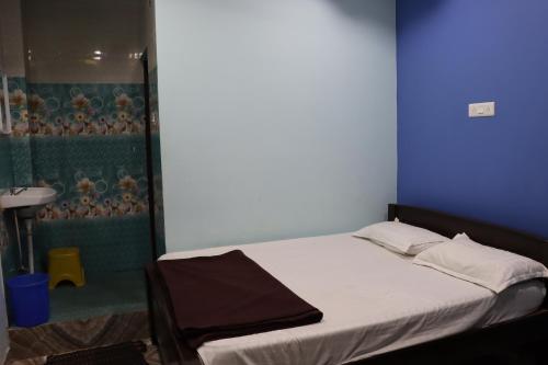 a bedroom with a bed and a shower at G.M Luxury Hotel in Srīsailam