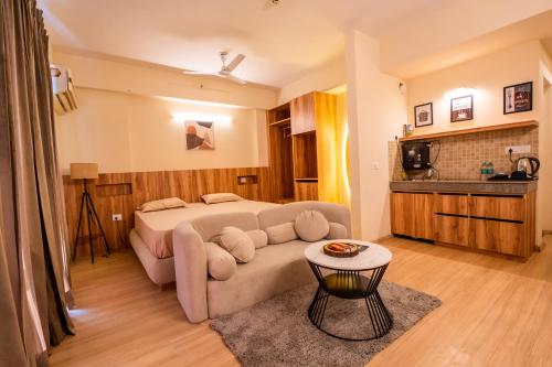 a living room with a couch and a bed at Skystay Lucknow in Lucknow