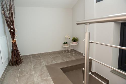 a hallway with white walls and a tile floor at Lovely Guesthouse - 58m2 mountain view in Ioannina