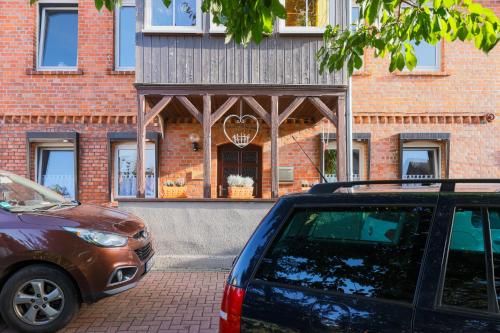 a car parked in front of a brick building at Zur Kleinen Hummel in Gernrode - Harz