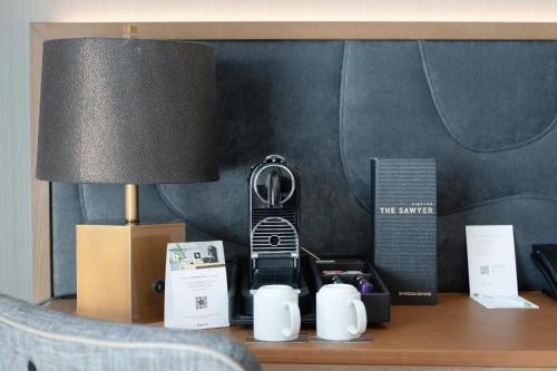 a table with a lamp and a phone on it at Kimpton Sawyer Hotel, an IHG Hotel in Sacramento