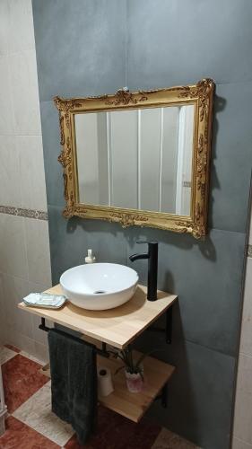a bathroom with a sink and a mirror on the wall at CASA SENDERO DEL RIO in El Bosque