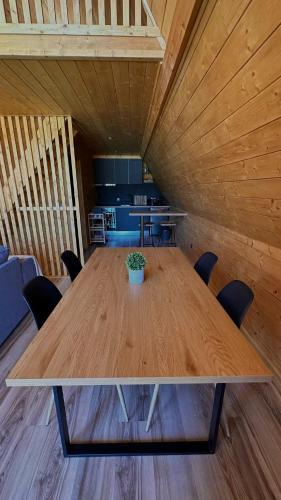 a large wooden table with chairs in a room at Casas da Madrinha in Arcos de Valdevez