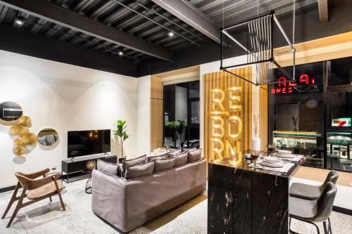 a living room with a couch and a table at Downtown Designer Apartments by ULIV in Tijuana