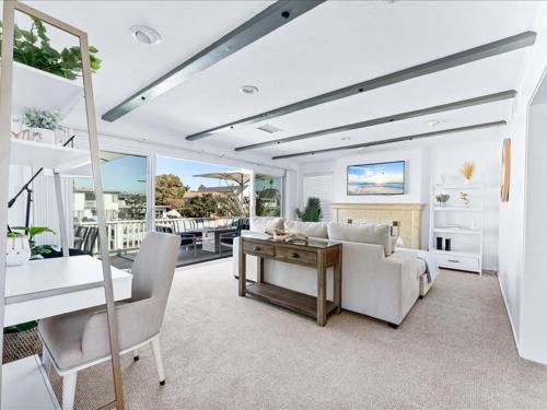 a living room with a couch and a table at Stunning Bayfront Home w Epic Dock on Peninsula in Newport Beach
