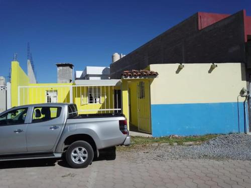 a silver truck parked in front of a building at CASA ACOGEDORA in Chignahuapan