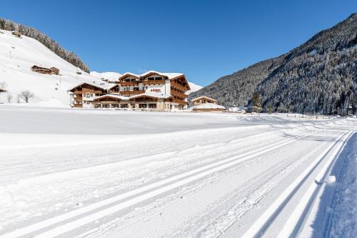 a view of the lodge in the snow at Hotel Eden in Tux