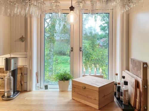 a kitchen with a large window and a wooden box at 4 star holiday home in Hok-By Traum in Hok
