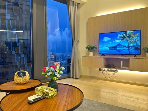a living room with a large window with a television at Premier Suites at STAR in Kuala Lumpur