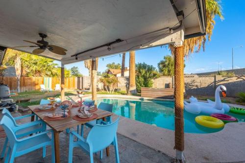 a patio with a table and chairs and a swimming pool at Pool -Hot Tub - Game Room - BBQ in Tempe