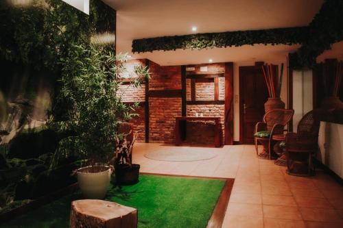 a living room with plants and a green rug at Posada Spa San Marcos in Santillana del Mar