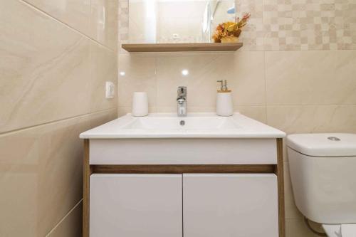 a bathroom with a sink and a toilet at Apartments in Veli Losinj 26474 in Veli Lošinj