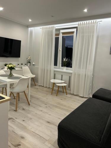 a living room with a bed and a dining room at Apartament na Dworcowej Centrum in Wrocław