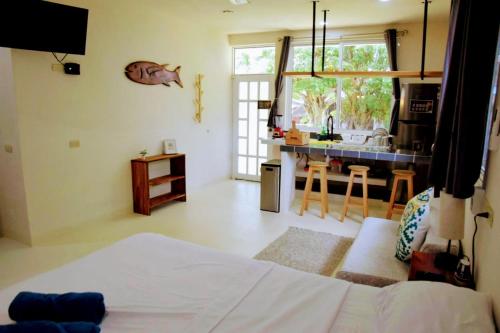 a living room with a bed and a kitchen at Mangal Suites in Brisas de Zicatela