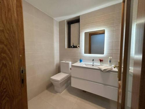 a bathroom with a toilet and a sink and a mirror at Luxurious Sliema Ferry central location in Sliema