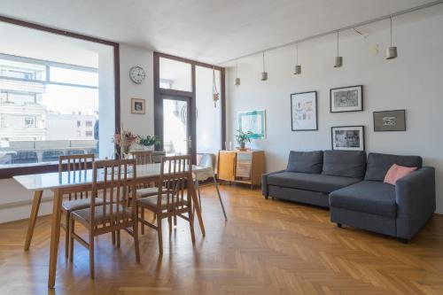 a living room with a couch and a table at Family apartment in the city centre - FREE parking garage in Ljubljana