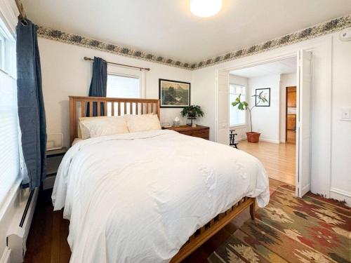 a bedroom with a large bed with a wooden headboard at Whimsical apartment near downtown Winooski in Winooski