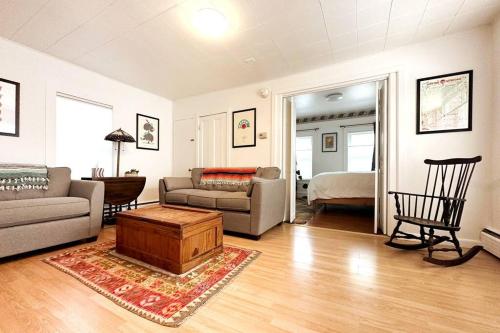 a living room with a couch and a table at Whimsical apartment near downtown Winooski in Winooski