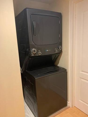 a computer monitor sitting on top of a stand in a room at Finished 2 BR Apartment in an Upscale Area of Ajax in Ajax