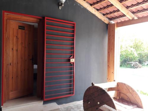 a room with a red door and a window at Dar Khedija in El Kheriba