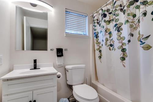 a bathroom with a toilet and a sink and a shower curtain at Retreat near UO, Autzen Stadium, Amazon Park (# 1) in Eugene
