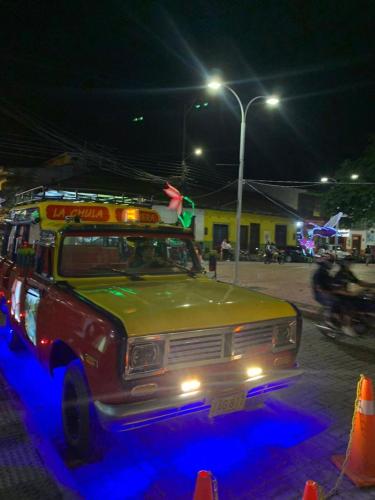 an old bus parked on a street at night at Eco-Glamping Shalom in Mariquita
