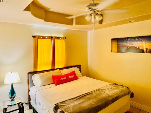 a bedroom with a bed with a red pillow on it at Brownsville Comfort 2 bedroom 1 bath , Spacious Kitchen and Outdoor Home in Brownsville