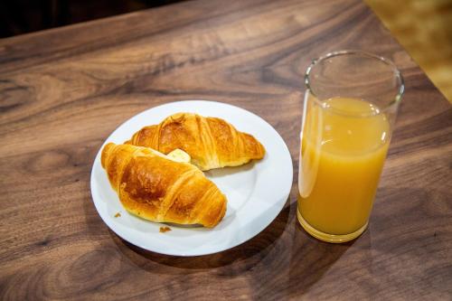 a plate with two croissants and a glass of orange juice at Kent Tonbridge Townhouse in Kent