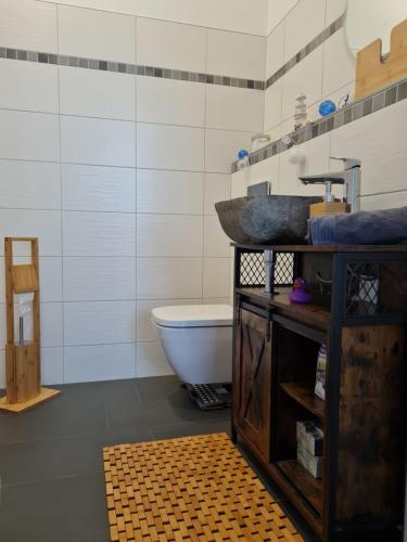 a bathroom with a sink and a bath tub at Ferienwohnung in 03159 Döbern 